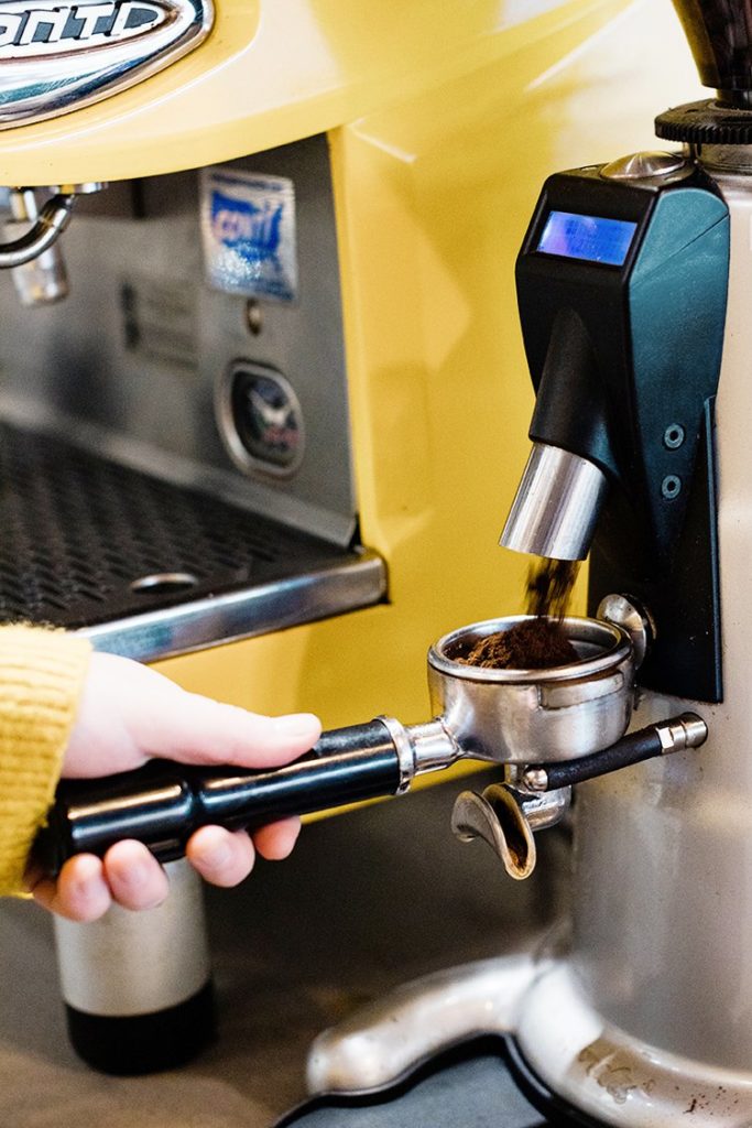 yellow espresso machine ground coffee in a porta-filter branding photo