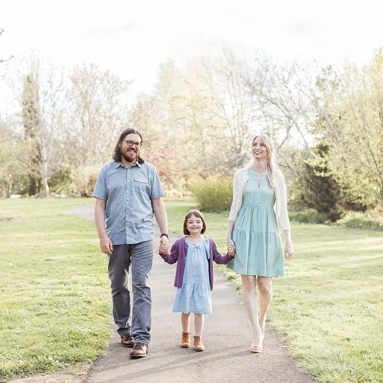 Eugene Oregon family walking on a path in the park while holding hands and smiling locations
