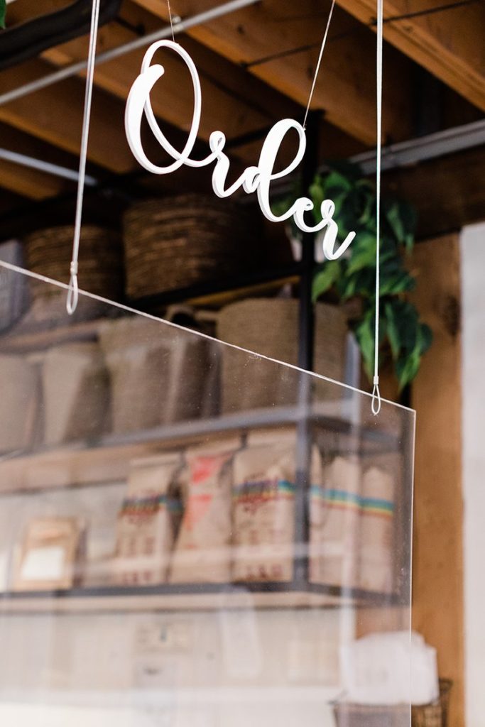 hanging order sign plexiglass screen in coffee shop captured by Eugene Oregon branding photographer
