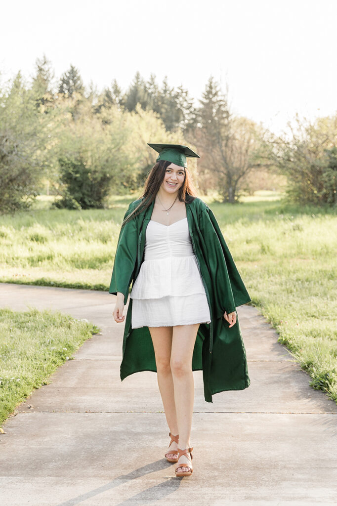 University of Oregon graduate in green cap and gown graduation Eugene girl