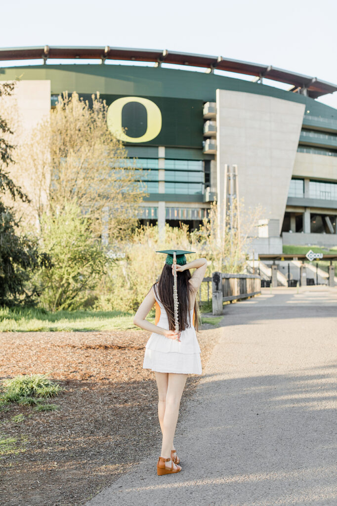 University of Oregon graduate in green cap Eugene girl flute