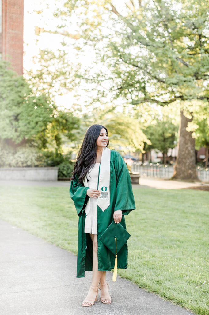 University of Oregon graduate in green gown sash Eugene girl
