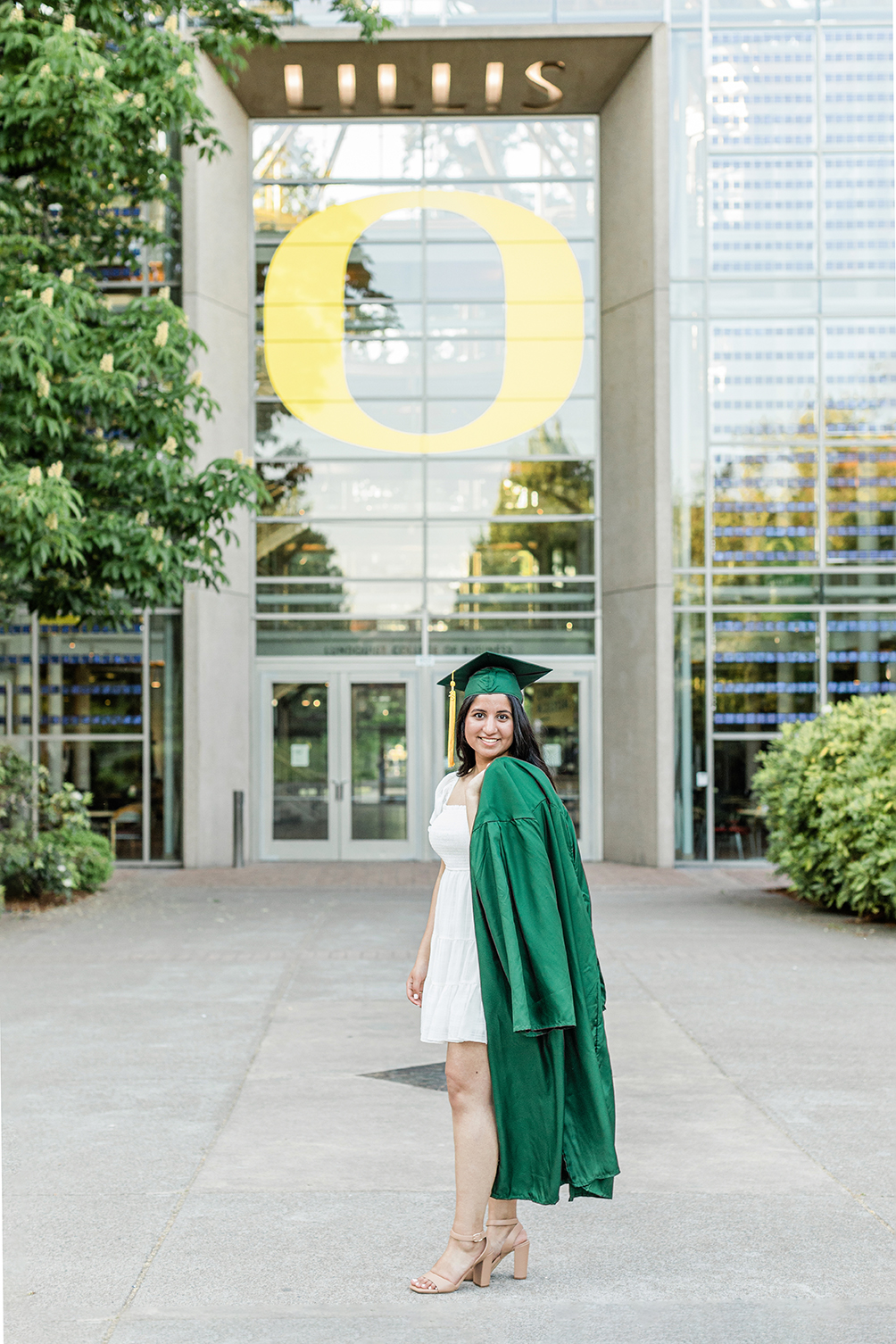 University of Oregon graduate in green cap and gown Eugene girl