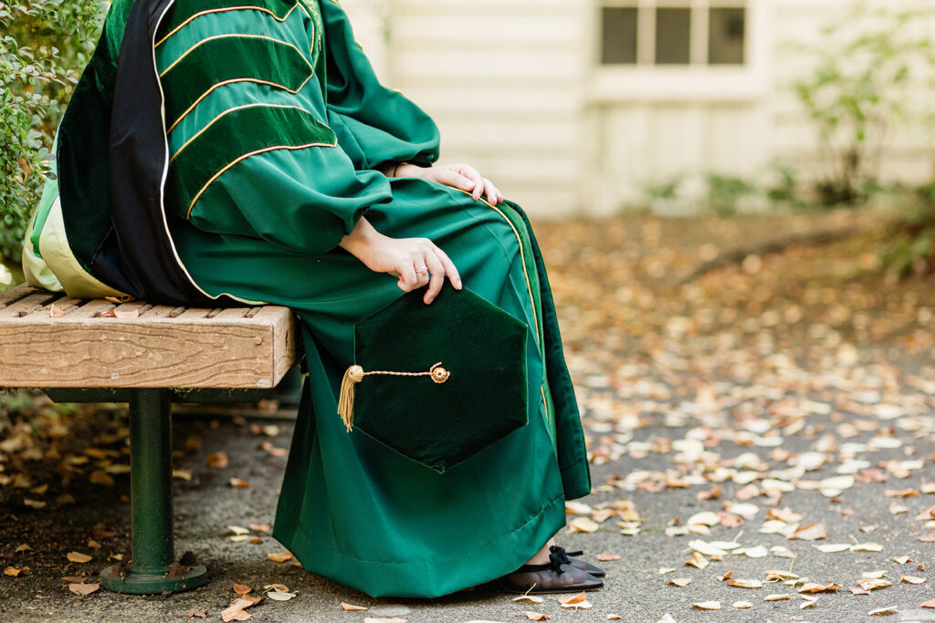 university of oregon doctorate student holds her cap university of oregon
