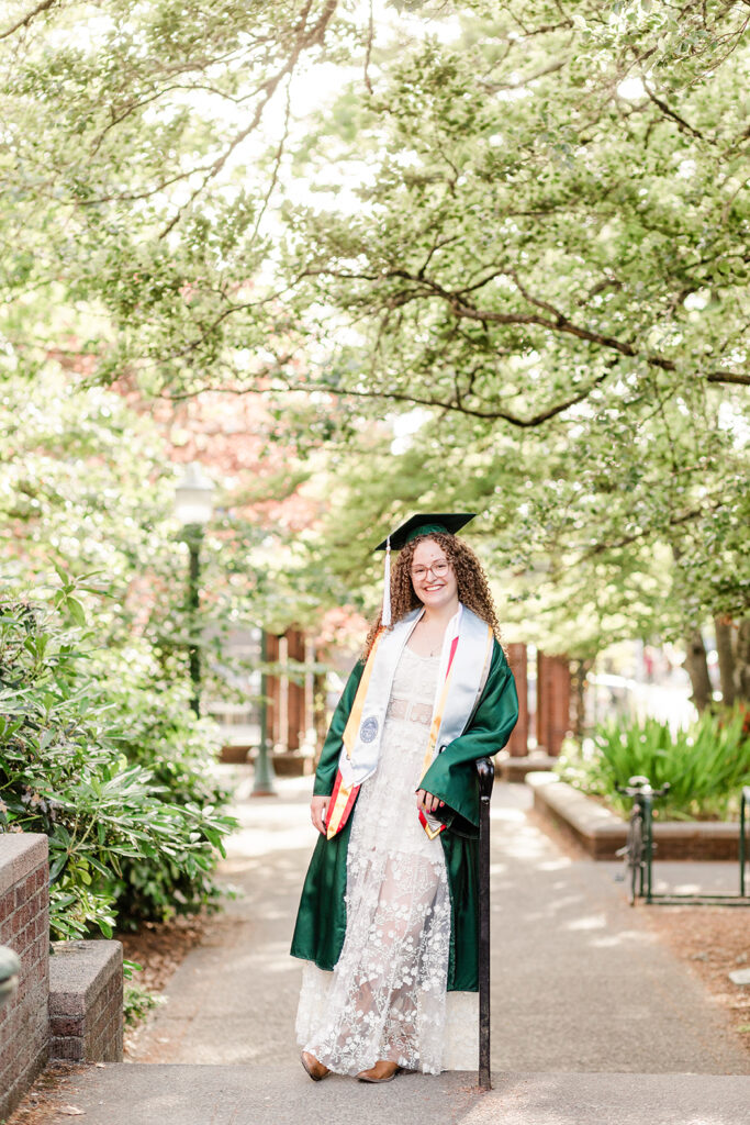 girl graduate graduation hat white dress trees buildings University of Oregon graduation photos in Eugene