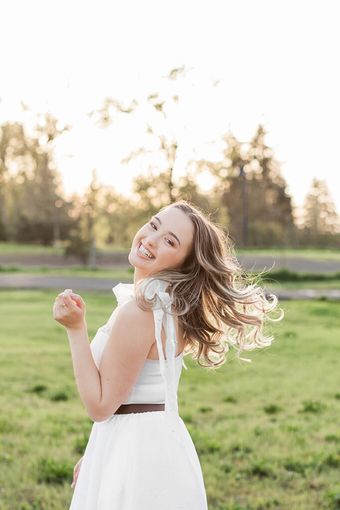 graduation golden hour fun university of oregon girl flipping hair