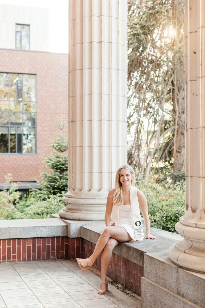 Girl wearing University of Oregon graduation stole on campus